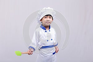Boy in chef uniform on white background