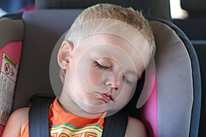 Boy in child car seat