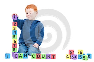 Boy child counting numbers with kids blocks