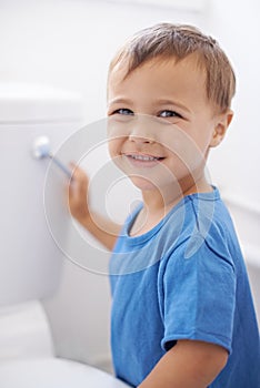 Boy child, flush toilet and potty training for smile, portrait or pride for development in family home. Kid, bathroom