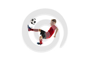 Boy, child, football player in uniform training, kicking ball with knee in mid-air in motion against white studio