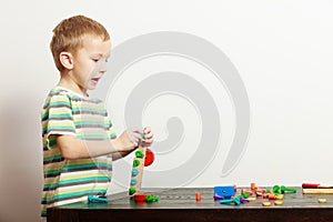 Boy child kid preschooler playing with building blocks toys interior