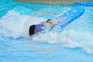 The boy in the pool in the summer autdoor. Holidays in the water Park. Joyful summer in the water photo