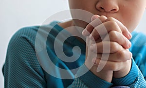 Boy child praying to God with hands together stock photo