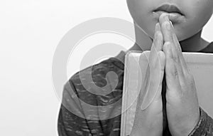 Boy child praying to God with hands together stock photo