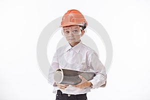 Boy child in a protective helmet and goggles with a construction