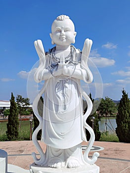 Boy Chinese angel in Buddhism style art with blue sky at Thailand.