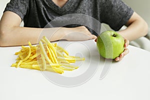 Boy chooses fruit or fast food