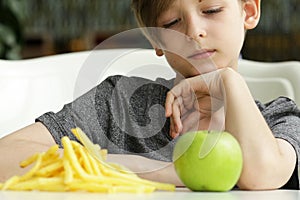 Boy chooses fruit or fast food