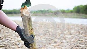 a boy chops firewood with an ax at a picnic