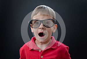 Boy with cinema 3d glasses with delighted face expression