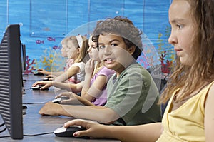 Boy With Classmates In Computer Lab