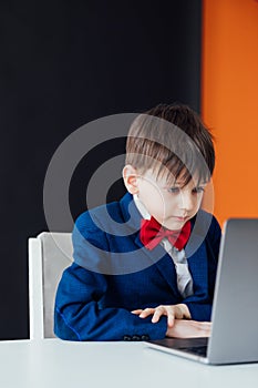 boy in the classroom at the computer online education skype communication