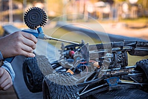 Boy cleaning his RC car with an air compressor