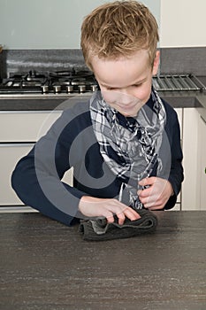 Boy cleaning the kitchen
