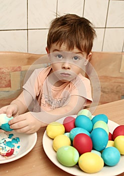 The boy cleans easter eggs
