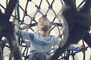 Boy climb rope tunnel