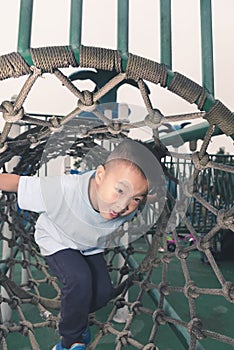 Boy climb rope tunnel