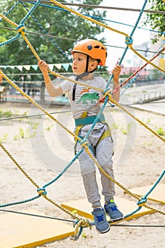 Boy at climbing activity in high wire forest park. Table Mountain Cableway kids special on again.