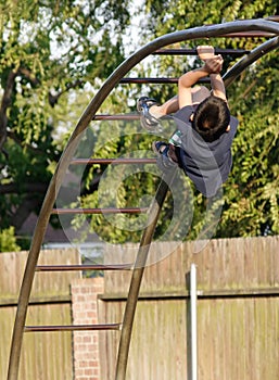 Boy climbing the monkey bars