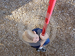 Boy Climbing Pole
