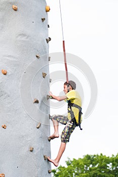 Boy climbing a rock wall