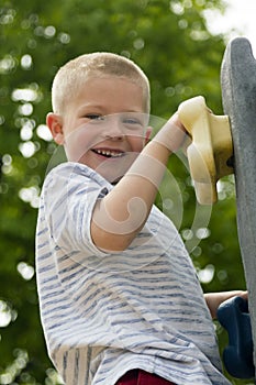 Boy Climbing Rock Wall Outdoors