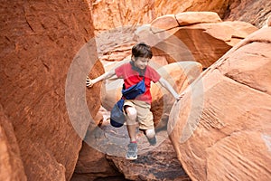 Boy Climbing Rocks in Arches National Park, Utah