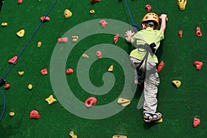 Boy on climbing wall photo