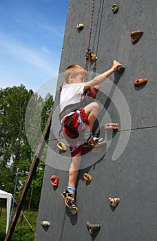Boy on climbing wall photo