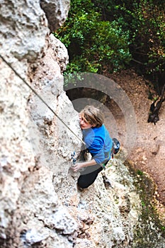 The boy is a rock climber.