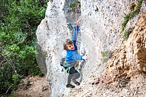 The boy is a rock climber.