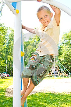 The boy climbs the ropes