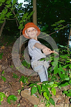 The boy climbs the slope of the ravine