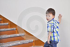 Boy climbs up the stairs