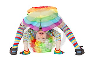 Boy in clown dress somersault isolated