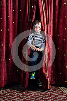 Boy Clown Jumping Through Stage Curtains