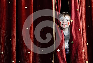 Boy Clown Peering Through Stage Curtains