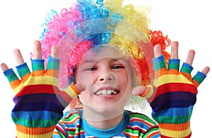 Boy in clown wig and multicolored gloves