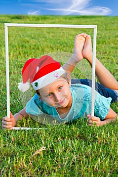 Boy in a clownish cap of Santa Claus