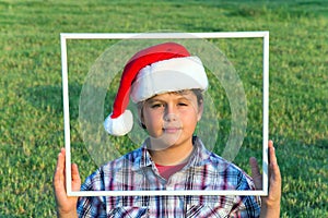 Boy in clownish cap of Santa Claus