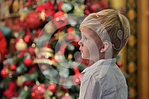 A Boy with Cochlear Implants and Christmas tree photo