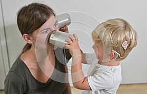 Boy with Cochlear Implants Playing Tin Can Phone