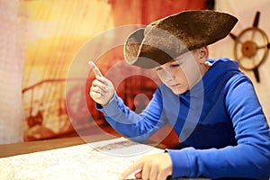 Boy in cocked hat with map