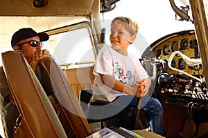 Boy in cockpit of private airplane photo