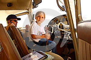 Boy in cockpit of private airplane