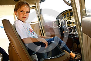 Boy in cockpit of private airplane