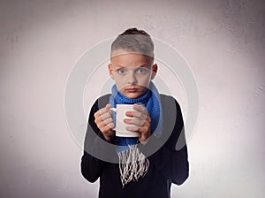 Boy cold, and drink warm tea