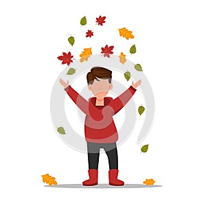 Boy collects leaves. The child runs through the autumn park.