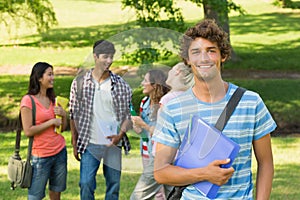 Boy with college friends in background at campus